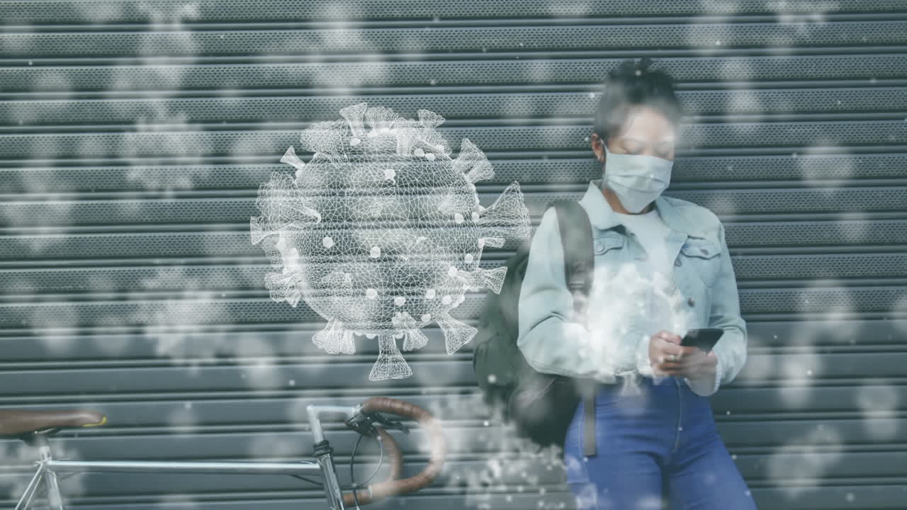 Animation of macro Covid-19 cells floating over Asian woman wearing mask and using a smartphone
