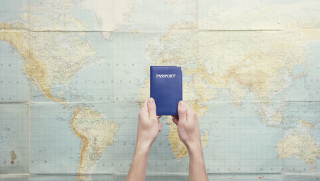 top view hands holding american passport thumbs up gesture vintage world map from above - red epic dragon