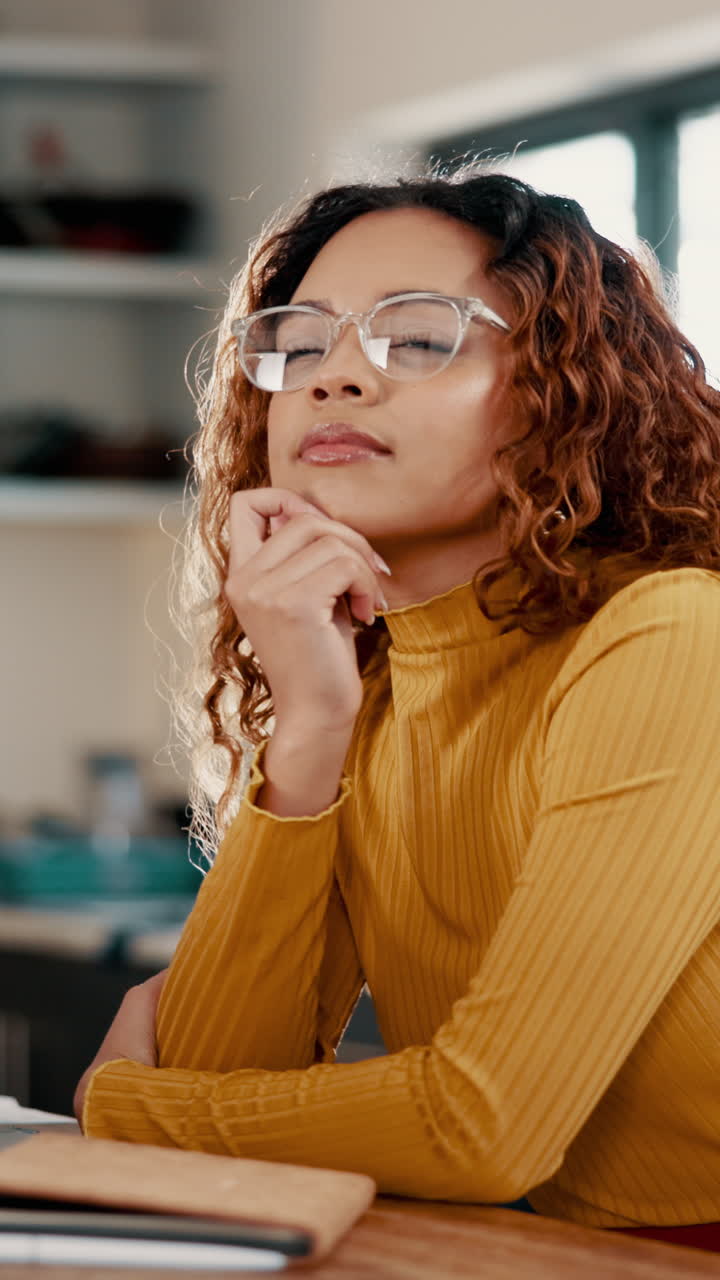 Thoughtful Young Woman with Glasses Pondering an Idea