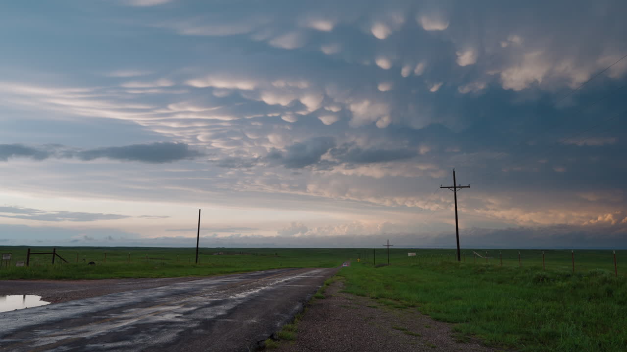 Colorful evening storm clouds over quiet country road