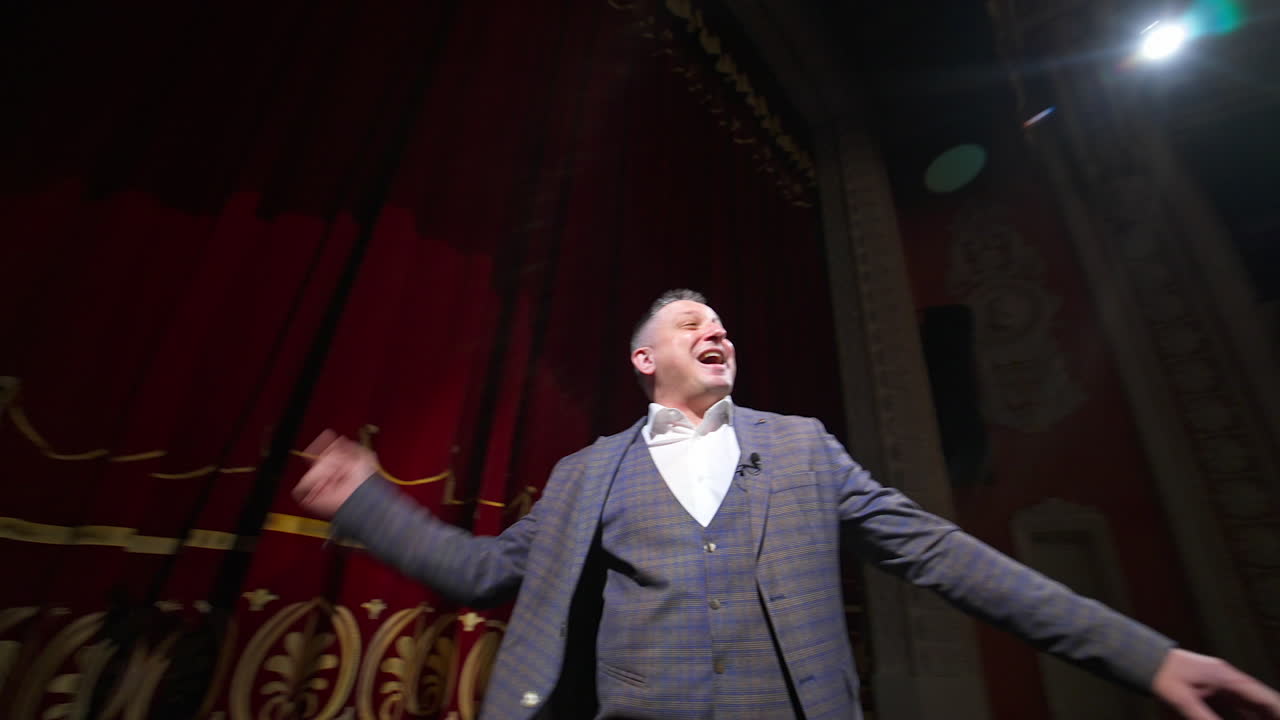 Young actor rehearsing a scene in a theater. Medium shot of an actor performing a monologue in a theater