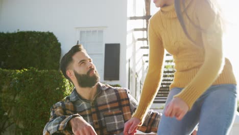 video of happy caucasian warmly dressed couple spending time in the garden