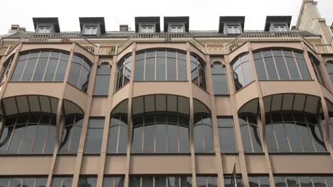 brown metallic iron facade of an activity building in rue reaumur in paris, france