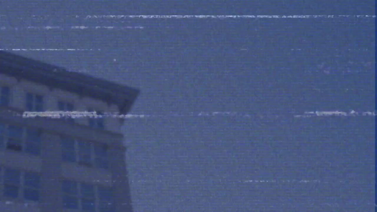 Animation of data processing over landscape with electricity pylons