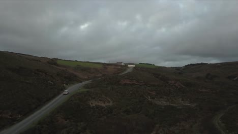 A-car-speeds-away-up-a-cliff-chased-by-the-ocean