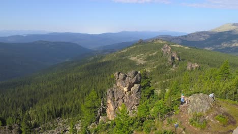 aerial view of a mountain range with a forest and rocks