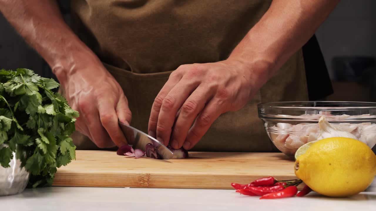 Chef Chopping Onion for a Fish Dish