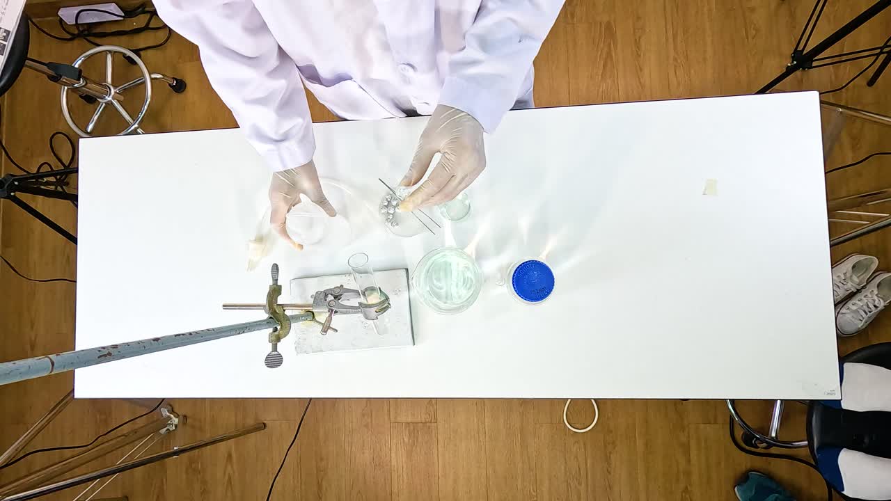 A scientist conducts a thermal decomposition experiment on copper carbonate using a Bunsen burner in a laboratory setting