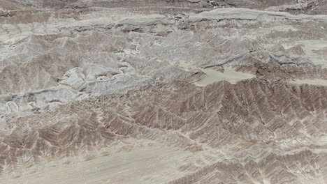 aerial flying over arid abstract landscape of the atacama desert