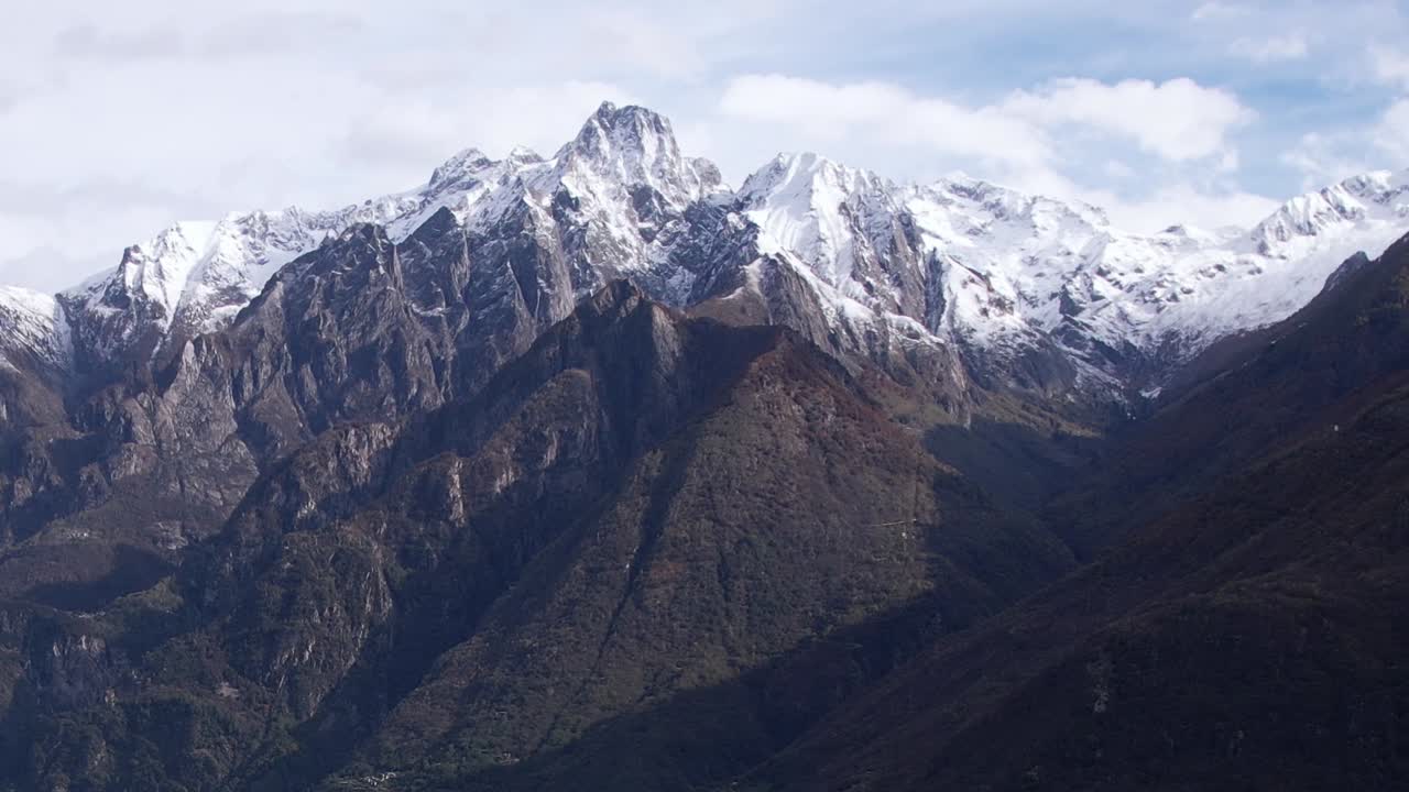 Dramatic aerial view of the snow-capped Alps in Italy during daylight
