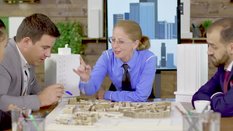 middle age female architect in a meeting with his team in the conference room