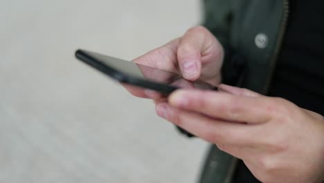 female hands messaging via smartphone outdoor