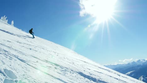 Person-snowboarding-on-snowy-mountain