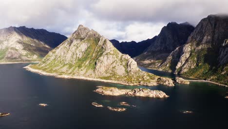 aerial orbit around the lofthaugen, with an amazing rainbow in the background, near henningsvær, lofoten islands, norway