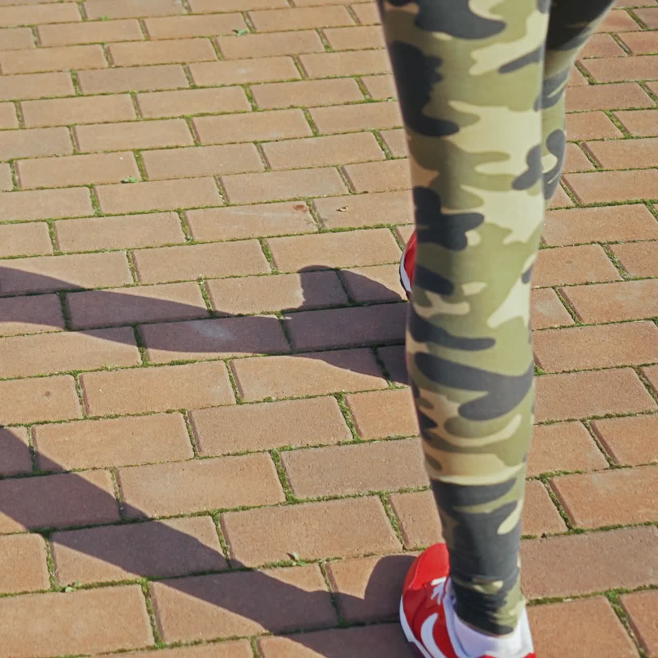 woman with an athletic pair of legs going for a jog or run on running race track