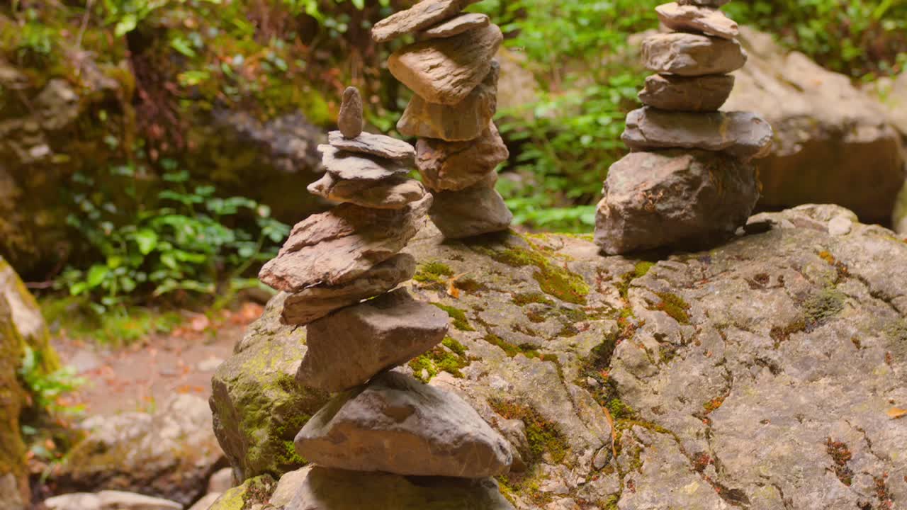 Rock Balancing - Rock Cairns As Trail Markers In The Forest. - closeup shot