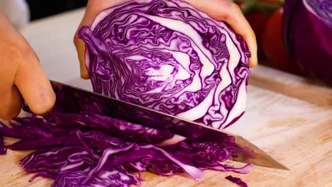 slicing fresh cabbage into thin strips