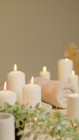 Vertical-Video-Still-Life-Of-Lit-Candles-With-Dried-Grasses-Incense-Stick-And-Soft-Towels-As-Part-Of-Relaxing-Spa-Day-Decor-3