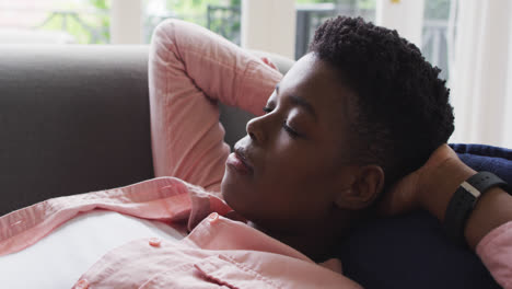 close up of african american woman sleeping on the couch at home