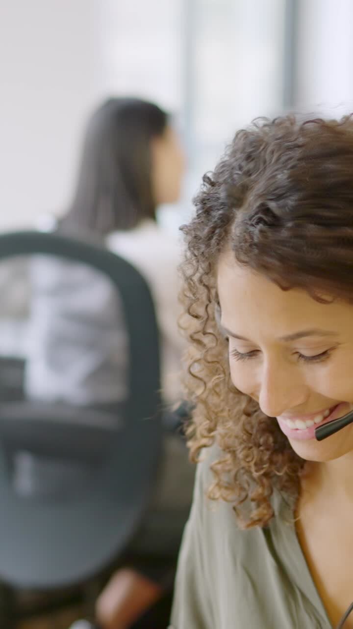 Telephone operator answering with a smile in a coworking space