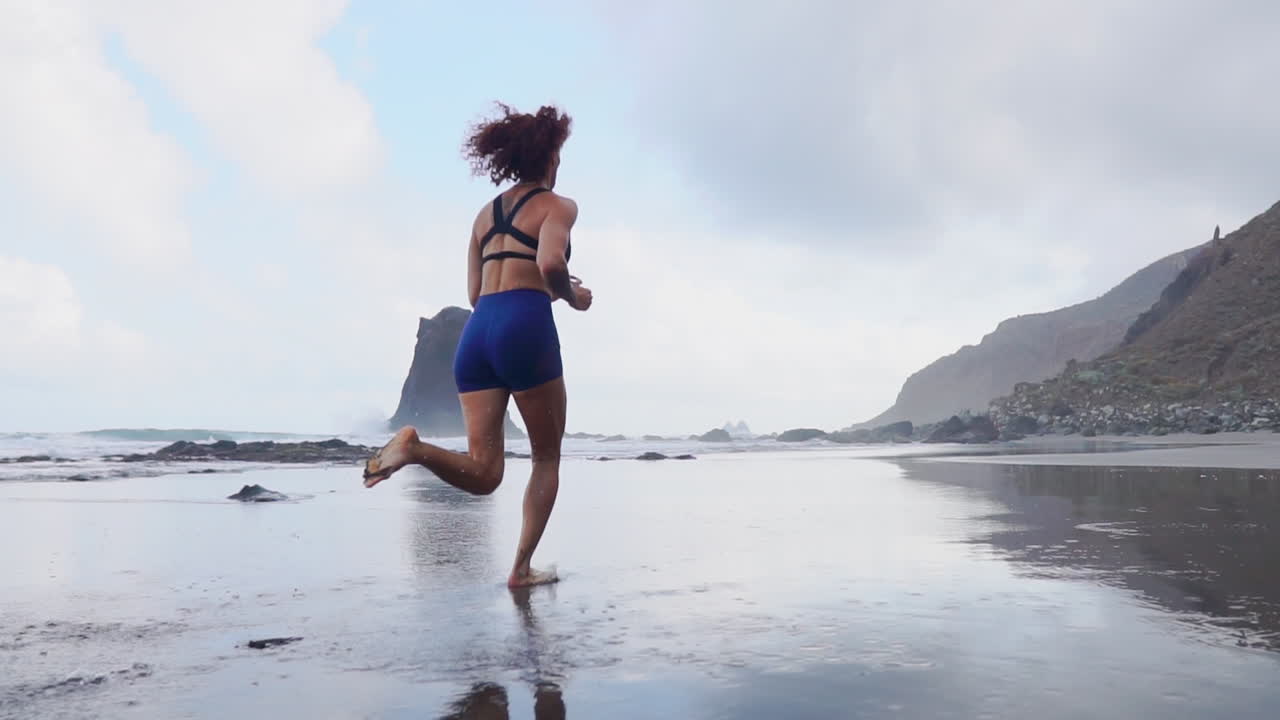 Aesthetic Pursuit: Slow Motion Fitness Run of a Curvaceous Athlete by the Sea