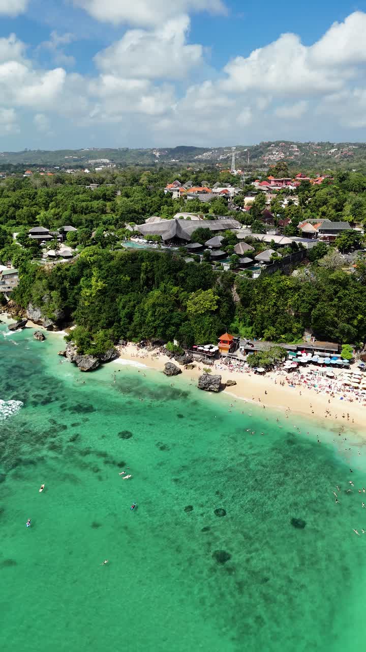 Aerial vertical view of Uluwatu Beach in Bali, Indonesia, Landscape with Surfers and Famous Cliff location at daylight