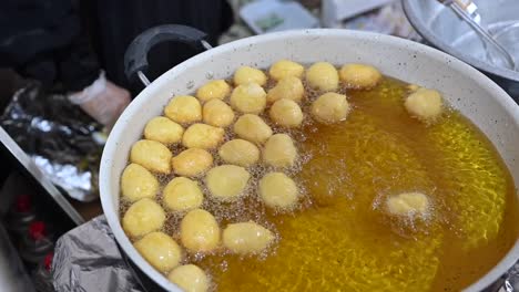 a traditional arab sweet called al logimat is being prepared