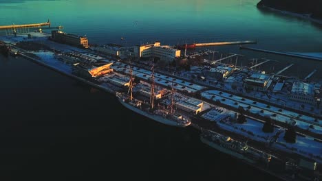 Drone-flying-towards-the-ship-at-the-sunset