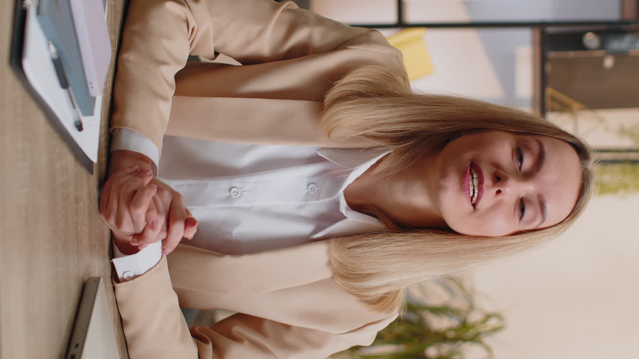 Businesswoman works on laptop at office talk on online communication video call with employee boss