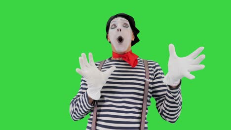 mime character with imaginary ball on a green screen, chroma key