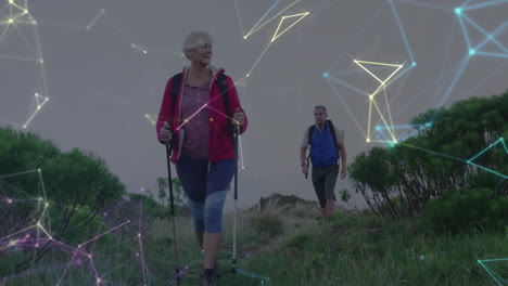 happy caucasian senior couple hiking in countryside, over moving network of connections