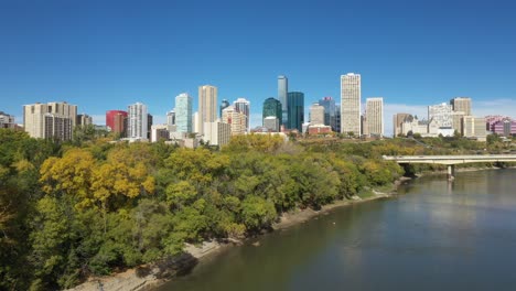 aerial drone view of the north saskatchewan river and downtown edmonton during autumn fall as seen from the rossdale area