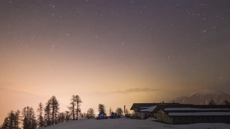 Timelapse-of-stars-moving-in-the-sky-over-snowy-and-foggy-landscape