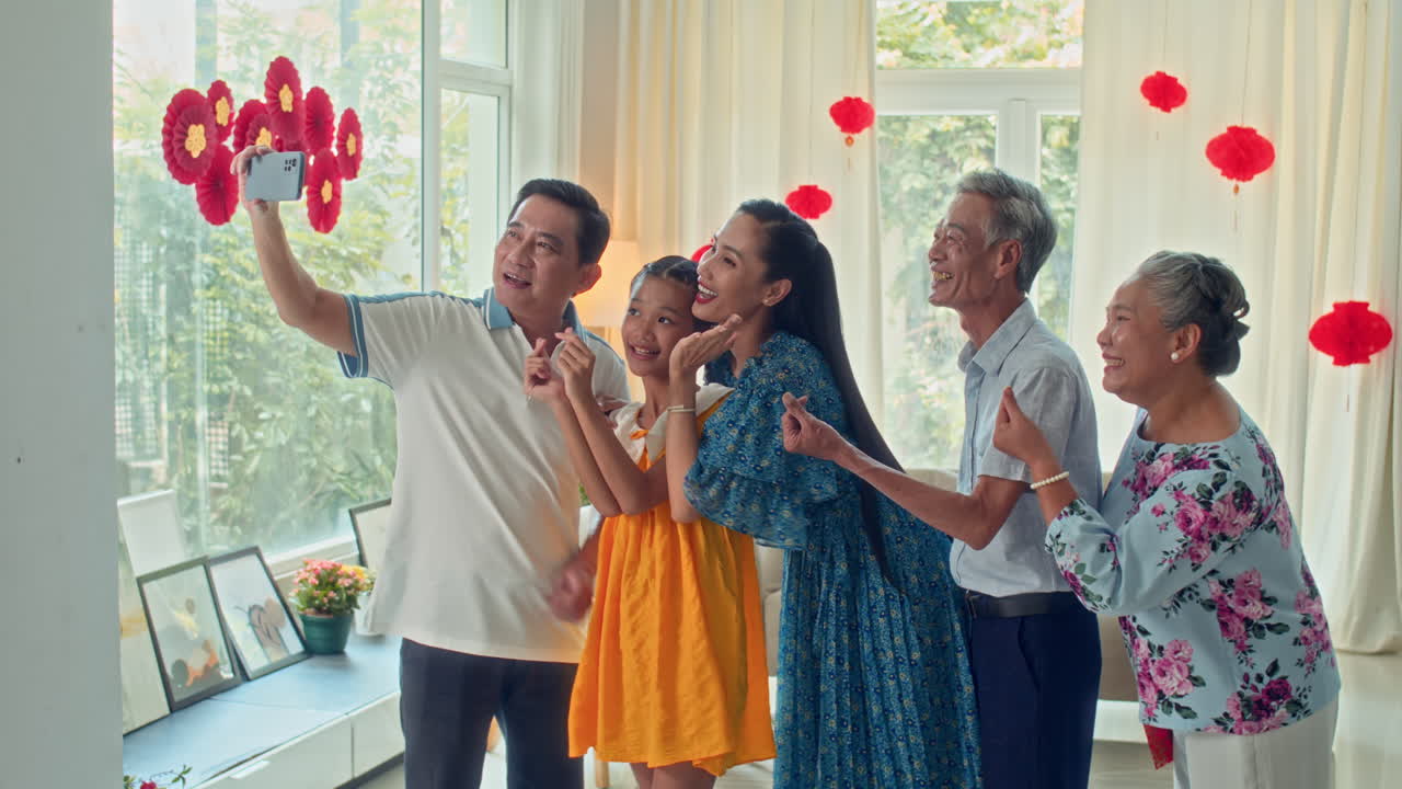 Vietnamese Family Taking Selfie on Phone during Tet Celebration