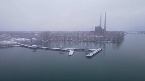 closed coal power plant and new park with pier nearby, aerial drone view