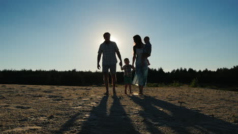 a family of four goes ahead mom dad and two sons the outline shooting