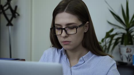 woman working on a laptop in an office