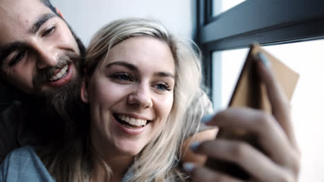 couple talking selfie with mobile phone in living room 4k