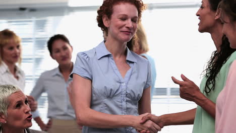 Businesswomen-shaking-hands-after-a-seminar