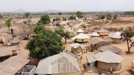 Aerial---a-village-in-Sub-Saharan-Africa,-wide-shot-forward