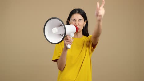 woman yelling into megaphone with raised fist and pointing
