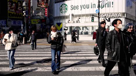 people crossing busy urban intersection in daylight