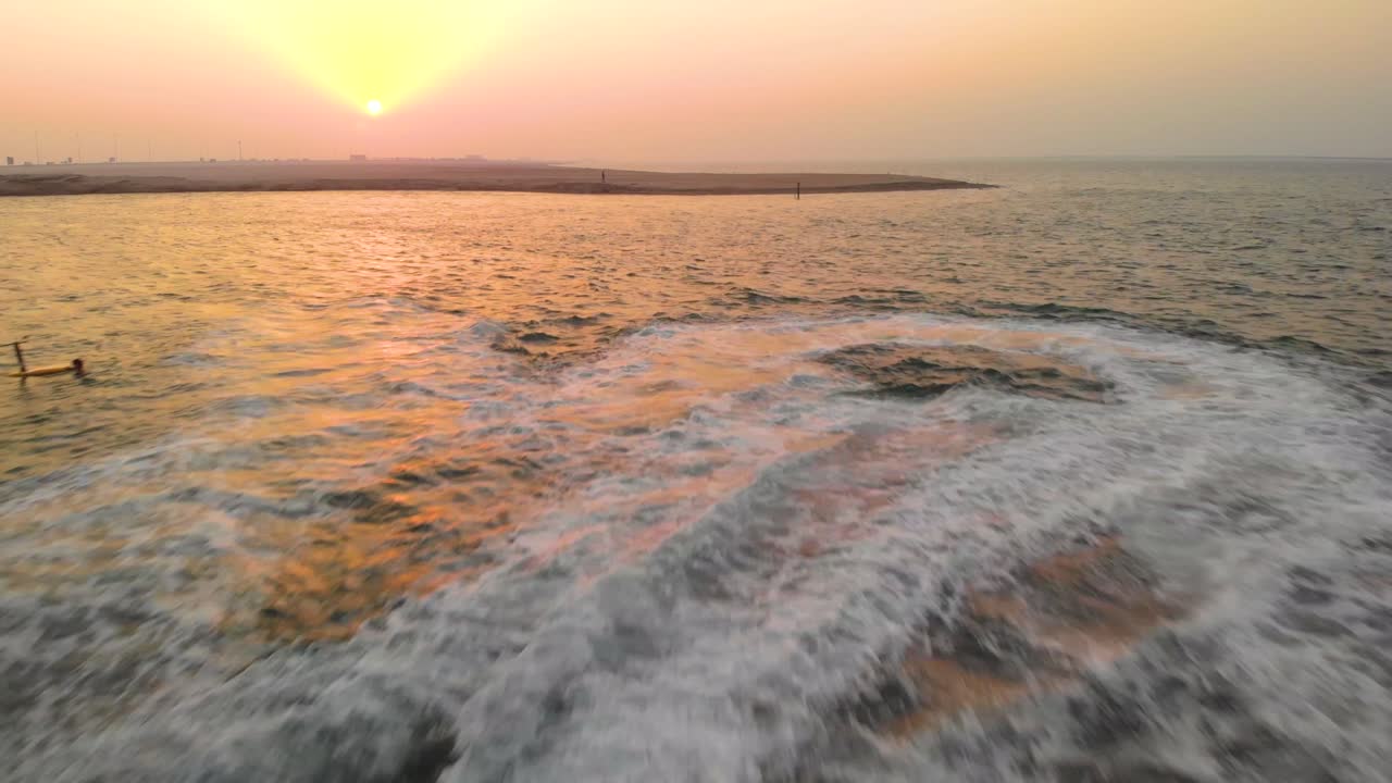 Amazing drone fly over three jet skis flying through Abu Dhabi Ocean coast during orange sunset aerial