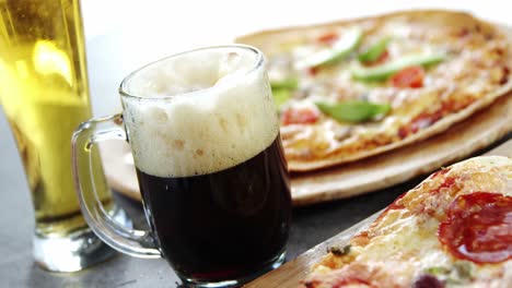 Delicious-pizza-with-glasses-of-beer-and-soft-drink