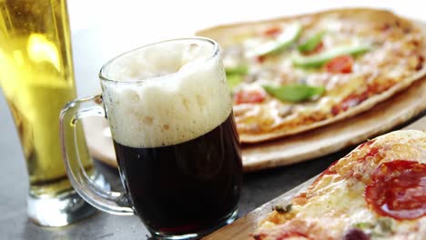 delicious pizza with glasses of beer and soft drink