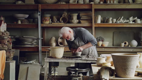 senior potter at work in his workshop