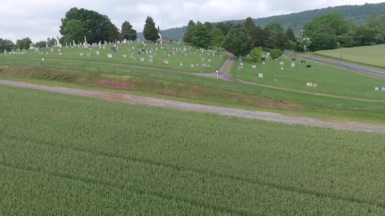 Green wheat field to cemetery