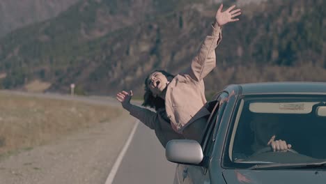 lady looks at sky with extended arms screams with happiness