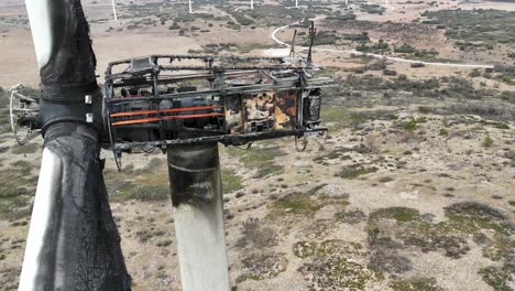 Extreme-close-up-aerial-view-of-a-wind-turbine-destroyed-by-a-fire