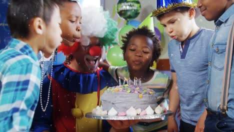 Animation-of-snow-falling-over-diverse-children-and-clown-at-birthday-party